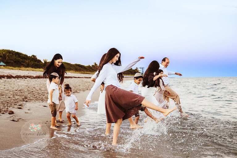 Siblings running and laughing on Boca Raton beach family photography session
