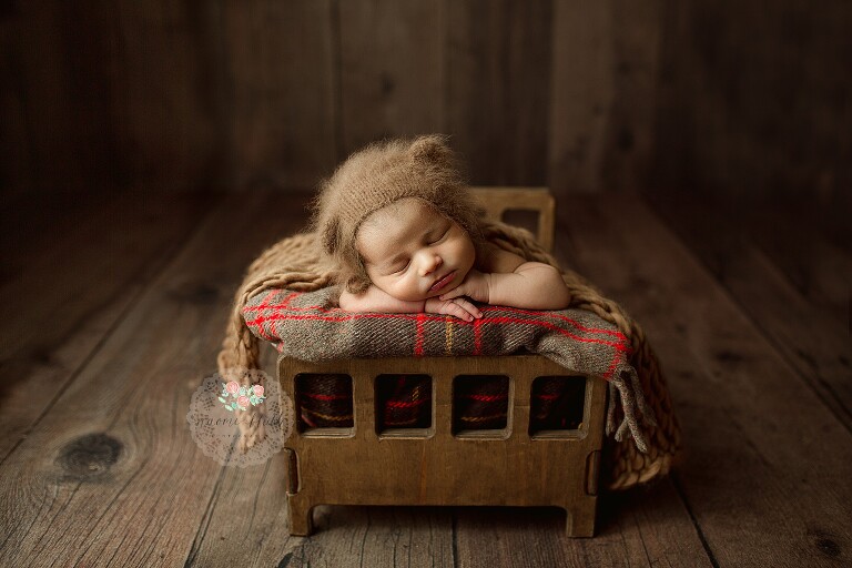 Best newborn photographer Boca Raton capturing sleepy newborn baby in neutral tones.